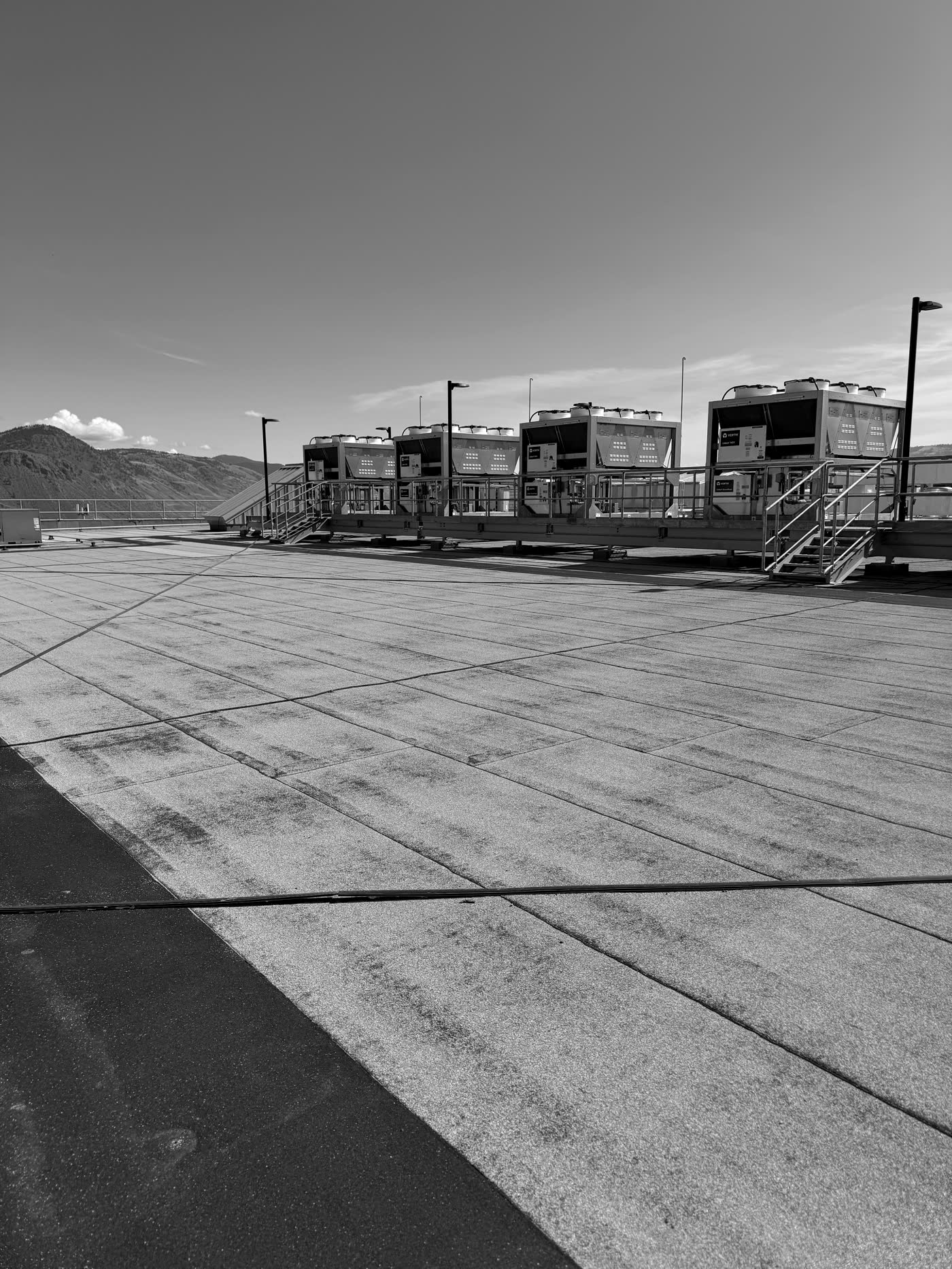 Five identical chillers on a galvanised steel cradle on a data centre roof